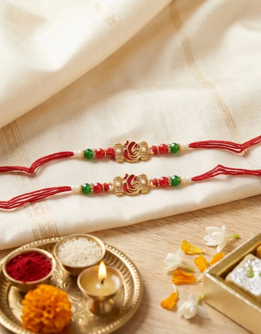 Two decorative bracelets with red, green, and gold beads on a light fabric background.