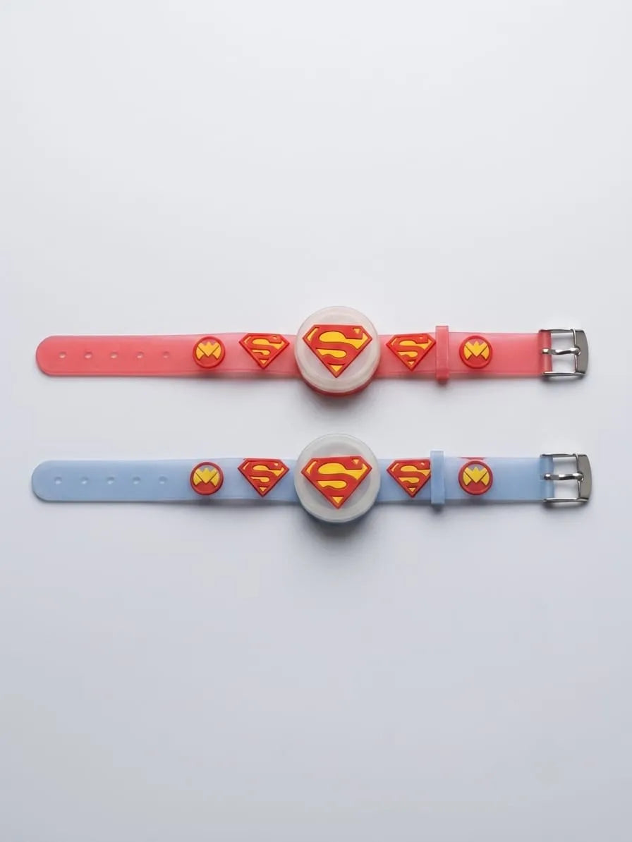 Two silicone watch bands with circular watch faces, featuring Superman logo designs in red and yellow. One band is pink and the other is light blue, laid flat on a white background.