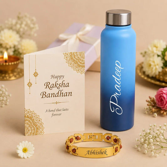 A personalized Raksha Bandhan gift set featuring a blue gradient water bottle with 'Pradeep' written on it, a gold-plated bracelet engraved with 'Abhishek', and a cream-colored greeting card with gold mandala designs and 'Happy Raksha Bandhan' text. The set is styled on a beige surface with decorative flowers, a gift box, and a lit candle.