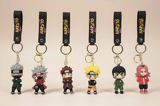 Set of Naruto-themed keychains with character figures on a beige background