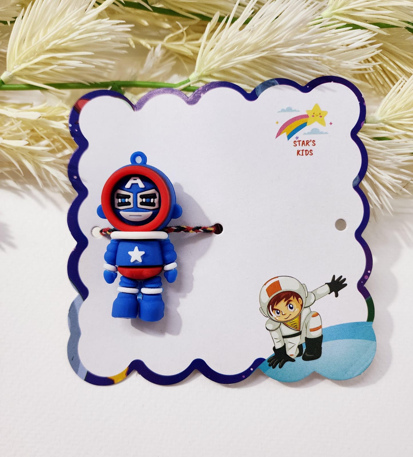 Toy figure of a character in a blue and red costume on a decorative card with cartoon illustrations.