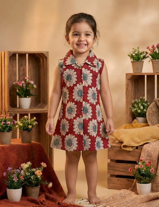 Girl wearing red daisy print sleeveless shirt dress front view