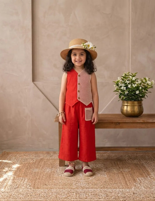 Front view of little girl wearing red cotton co-ord set with contrast panel and hat