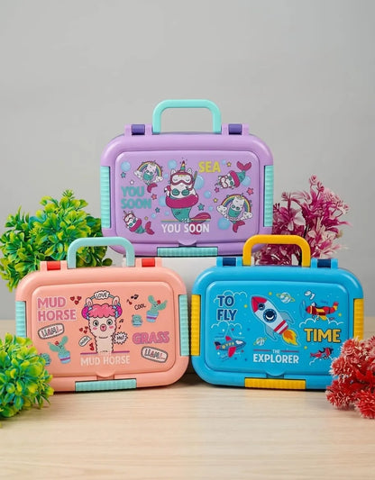 Three colorful children's lunch boxes with cartoon designs on a wooden surface.