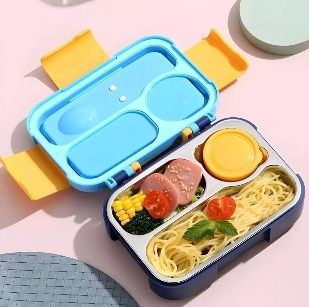 Colorful bento box with spaghetti, vegetables, and a yellow container on a pink background