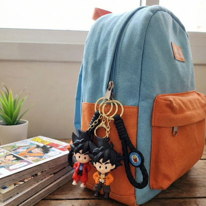 Blue and orange backpack with keychains on a wooden surface