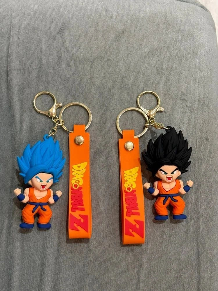 Two keychains featuring characters from a popular animated series on an orange strap with 'Dragon Ball Z' branding.