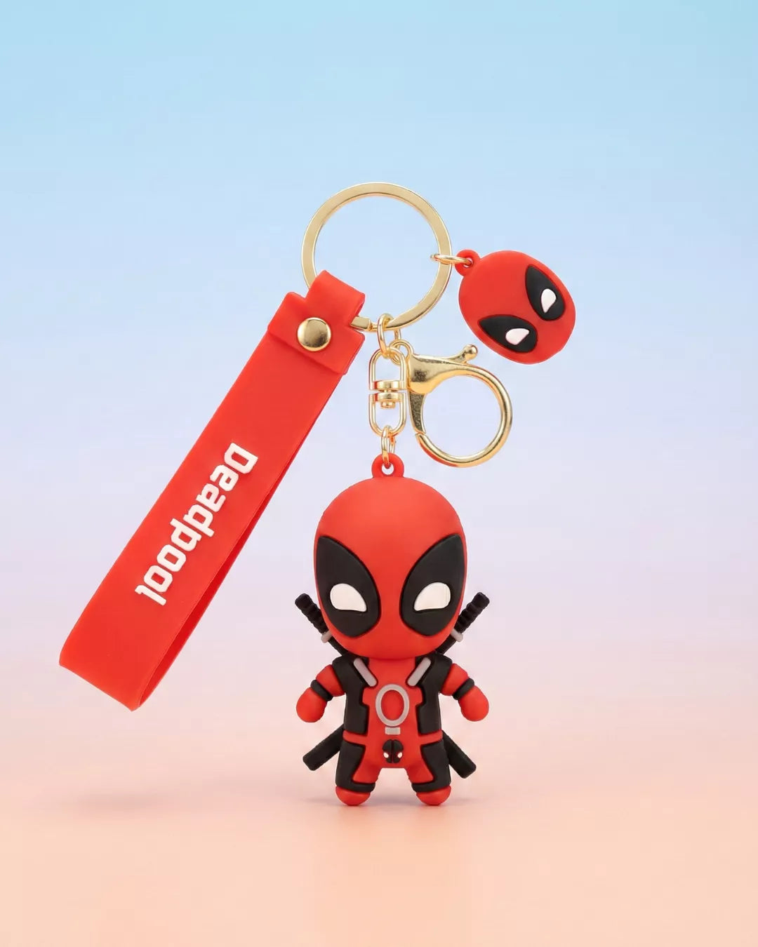 Deadpool keychain with red strap on a gradient background