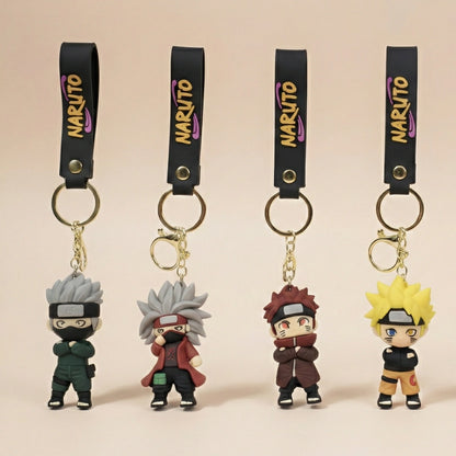 Four Naruto-themed keychains on a beige background