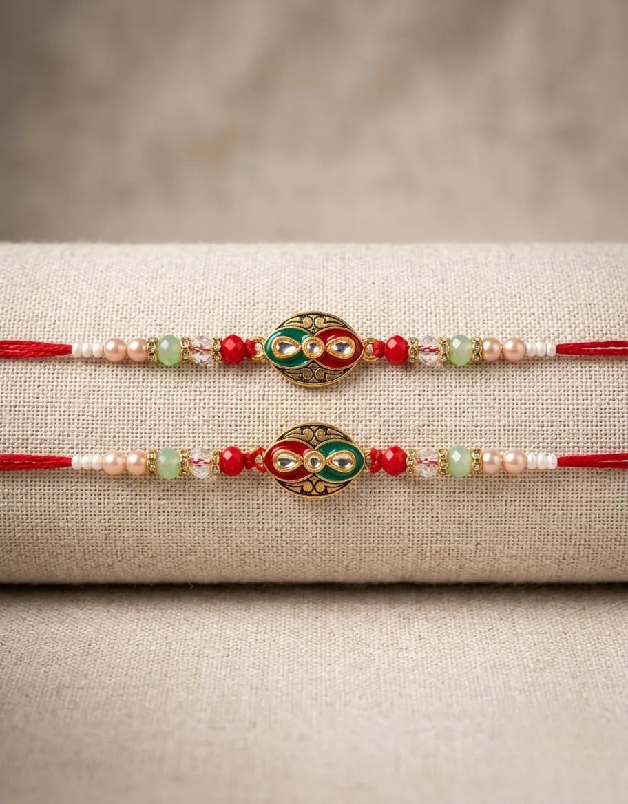 Two decorative bracelets with red, green, and gold elements on a textured beige surface.