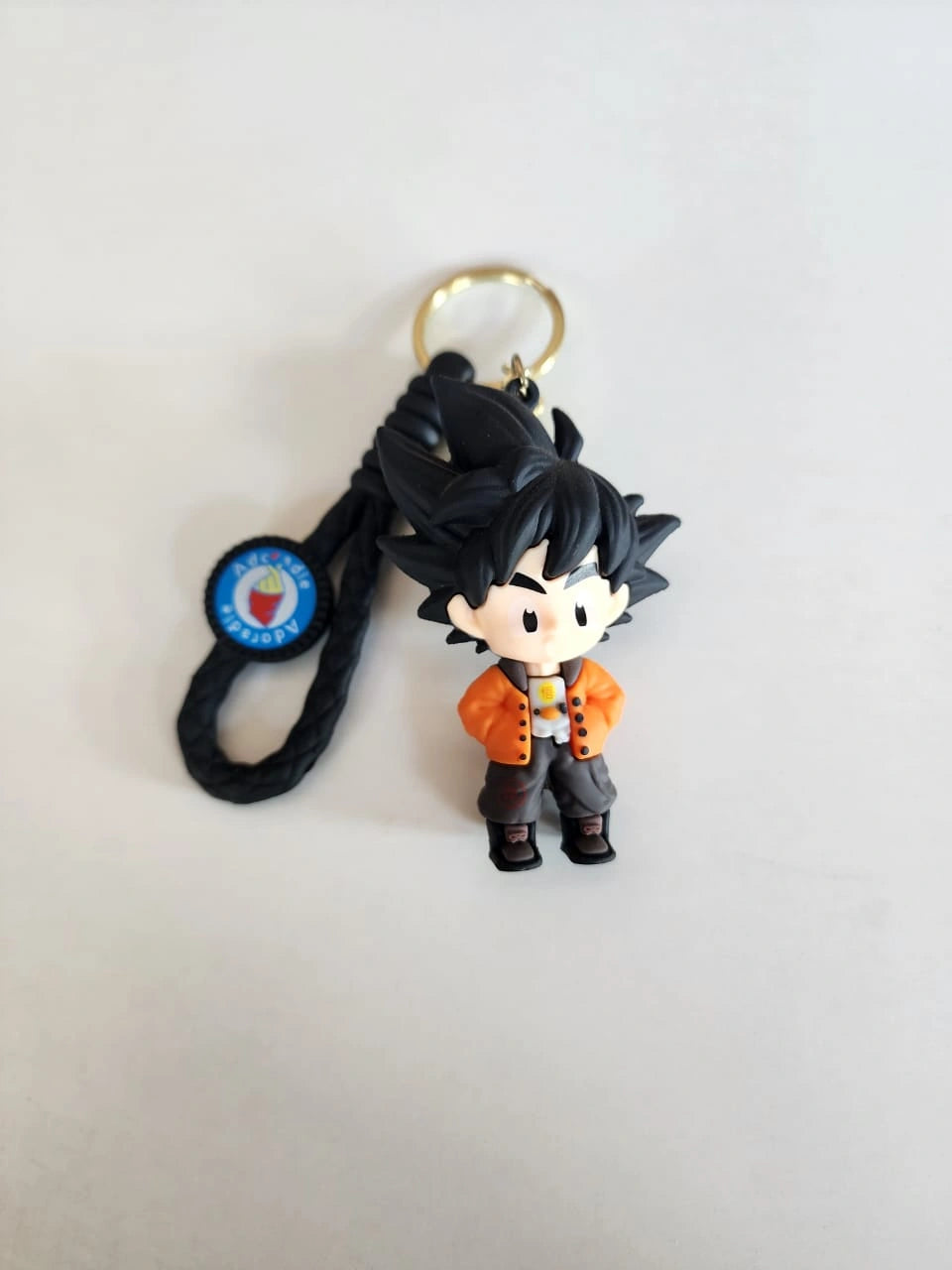 Keychain with a character figure on a light gray background