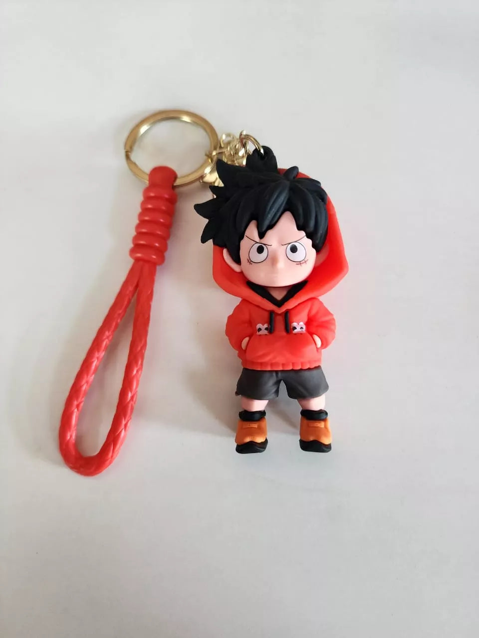 Keychain with a character in a red hoodie on a light gray background