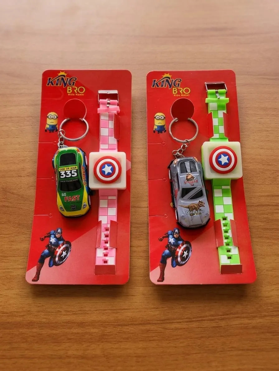 Two Captain America themed wristwatch keychains in their original red blister packaging, displayed side-by-side on a wooden table. One features a green race car keychain with a pink checkered strap, and the other features a gray car keychain with a green checkered strap.