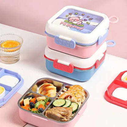 A stack of three reusable lunch boxes with a cartoon pig design on the lid, shown alongside an open compartment lunch box filled with food on a pink tabletop.