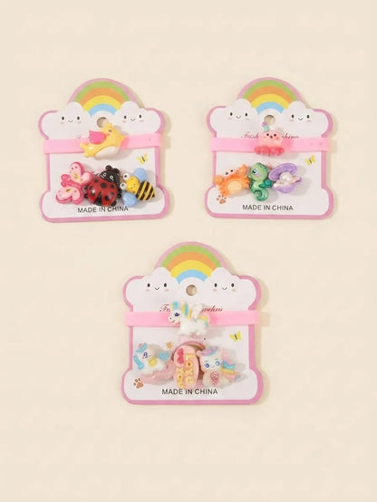 Three small hair accessory sets on cloud-shaped cards, each set containing colorful hair clips or ties with animal and nature motifs like ladybugs, bees, butterflies, and rainbows. The cards are pink and white with 'MADE IN CHINA' printed at the bottom.