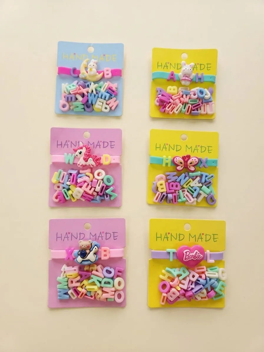 Six packages of colorful alphabet letter beads arranged in a 2x3 grid on a light beige background. Each package contains pink and multicolor alphabet beads, with some packages featuring cartoon character charms (such as Mickey Mouse and Minnie Mouse) and a Barbie logo on the card.
