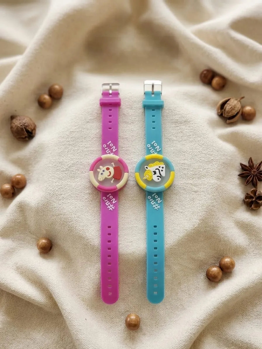 Two silicone wristwatches with colorful straps, one pink and one blue, displayed on a beige fabric background with decorative wood beads and star anise.