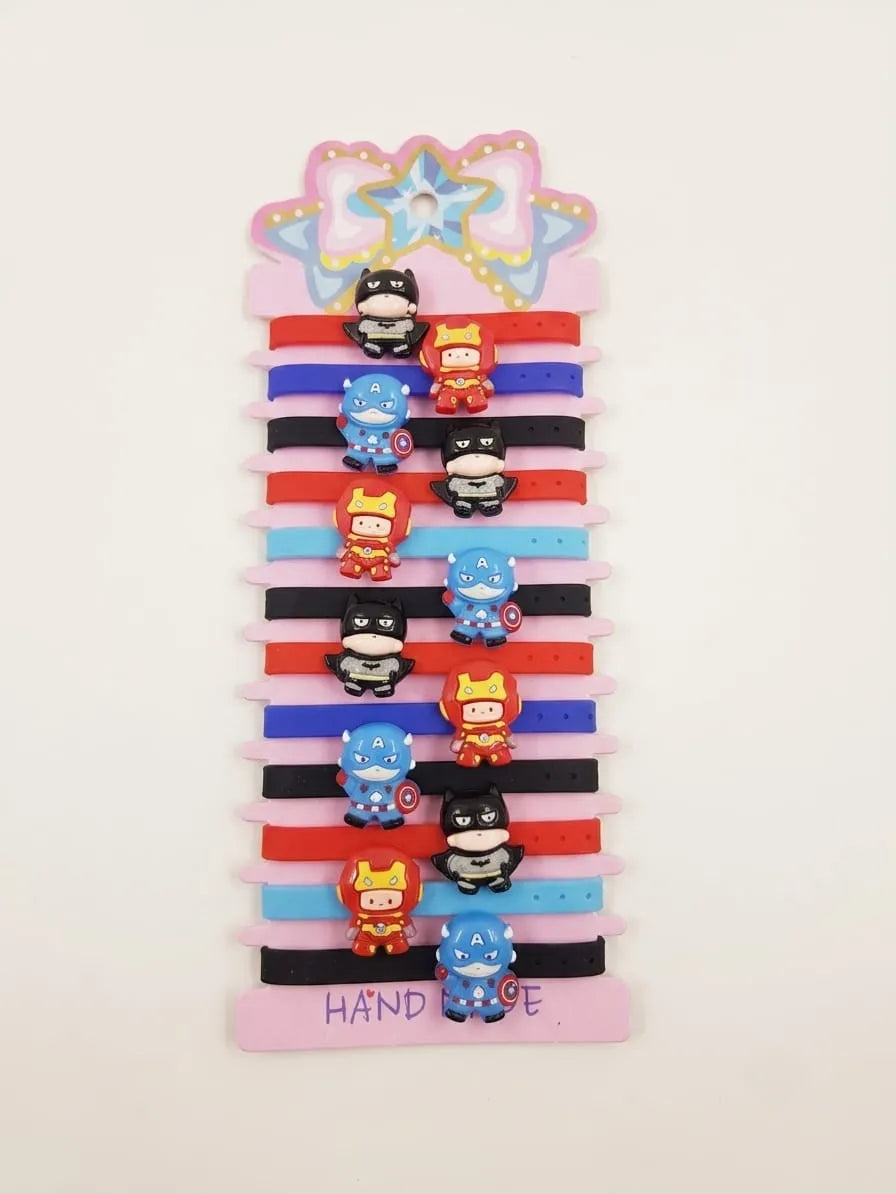 A set of five kids' elastic hair ties with cartoon superhero charms, displayed on a pink and white striped cardboard hanger. The hair ties come in red, black, blue, and light blue colors, and feature mini charms of Batman, Superman, Spider-Man, Captain America, and Iron Man.
