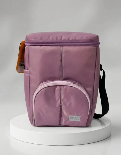 Purple insulated lunch bag on a white pedestal with a gray background