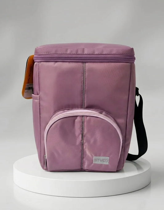 Purple insulated lunch bag on a white pedestal with a gray background