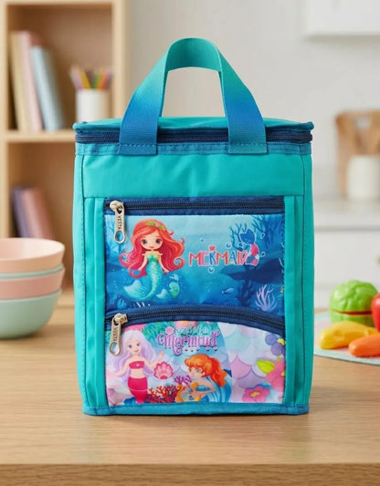 Teal lunch bag with Mermaid Man and Mermaid Minnie design on a wooden table.
