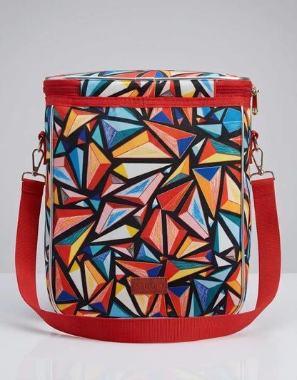 Colorful geometric-patterned bag with red accents on a light gray background