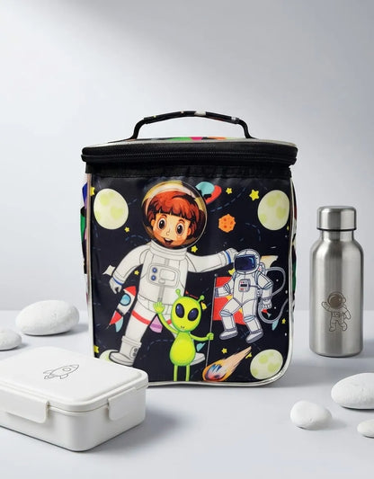  insulated lunch bag with space-themed design featuring astronauts and alien, next to a silver water bottle on a light gray background.