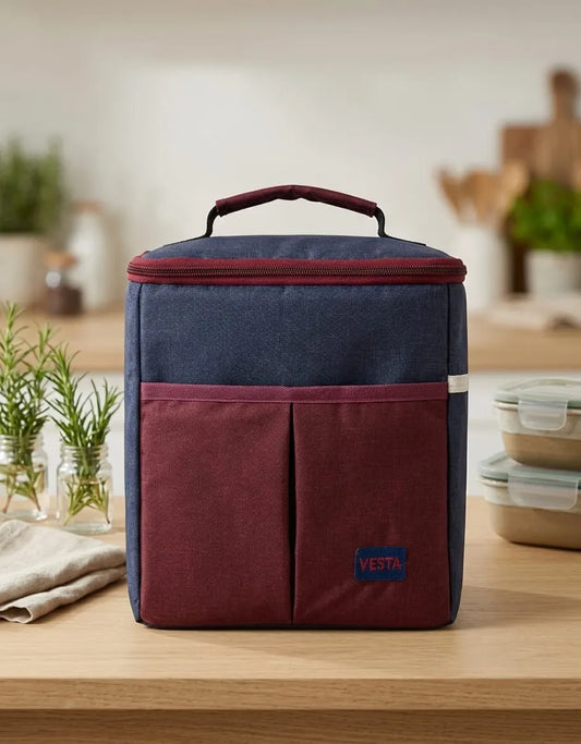 Blue and red insulated lunch bag on a wooden surface with a blurred kitchen background