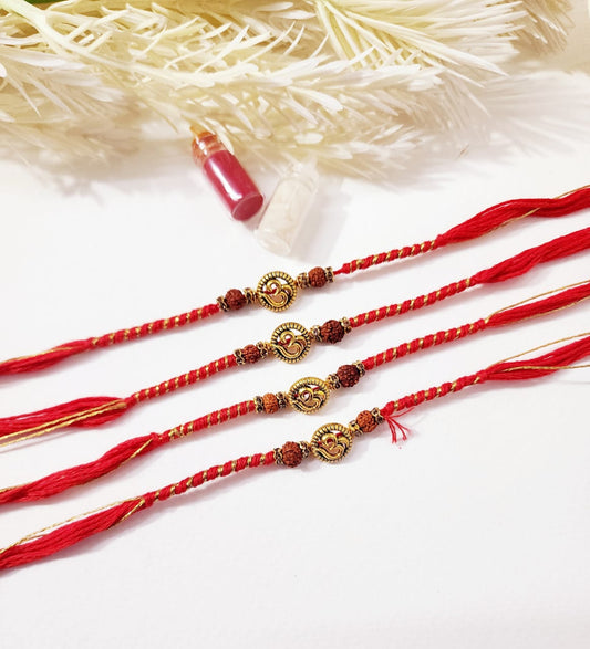Three red and gold bracelets on a white background