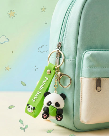 Panda-shaped keychain with a green tag on a mint green backpack with a light background.