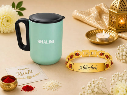 A festive gift arrangement featuring a mint green insulated mug with a black lid and handle, personalized with the name 'SHALINI' in white. Next to it is a gold-toned bracelet engraved with 'Abhishek' and accented with red stones.