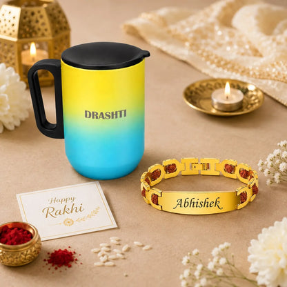 A personalized Rakhi gift set featuring a yellow-to-blue gradient travel mug with a black lid, a gold-plated bracelet engraved with 'Abhishek', a 'Happy Rakhi' greeting card, and festive decorative props on a beige surface.
