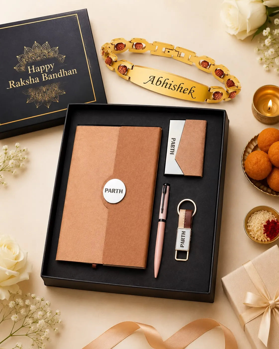 A personalized Raksha Bandhan gift set in a black box, featuring a gold-plated engraved bracelet, a brown notebook, a pen, a small card, and a USB drive, styled with flowers, a lit candle, and sweets on a beige background.