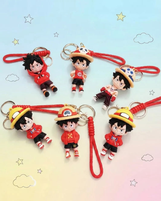 Set of five cartoon character keychains with red strings on a gradient background