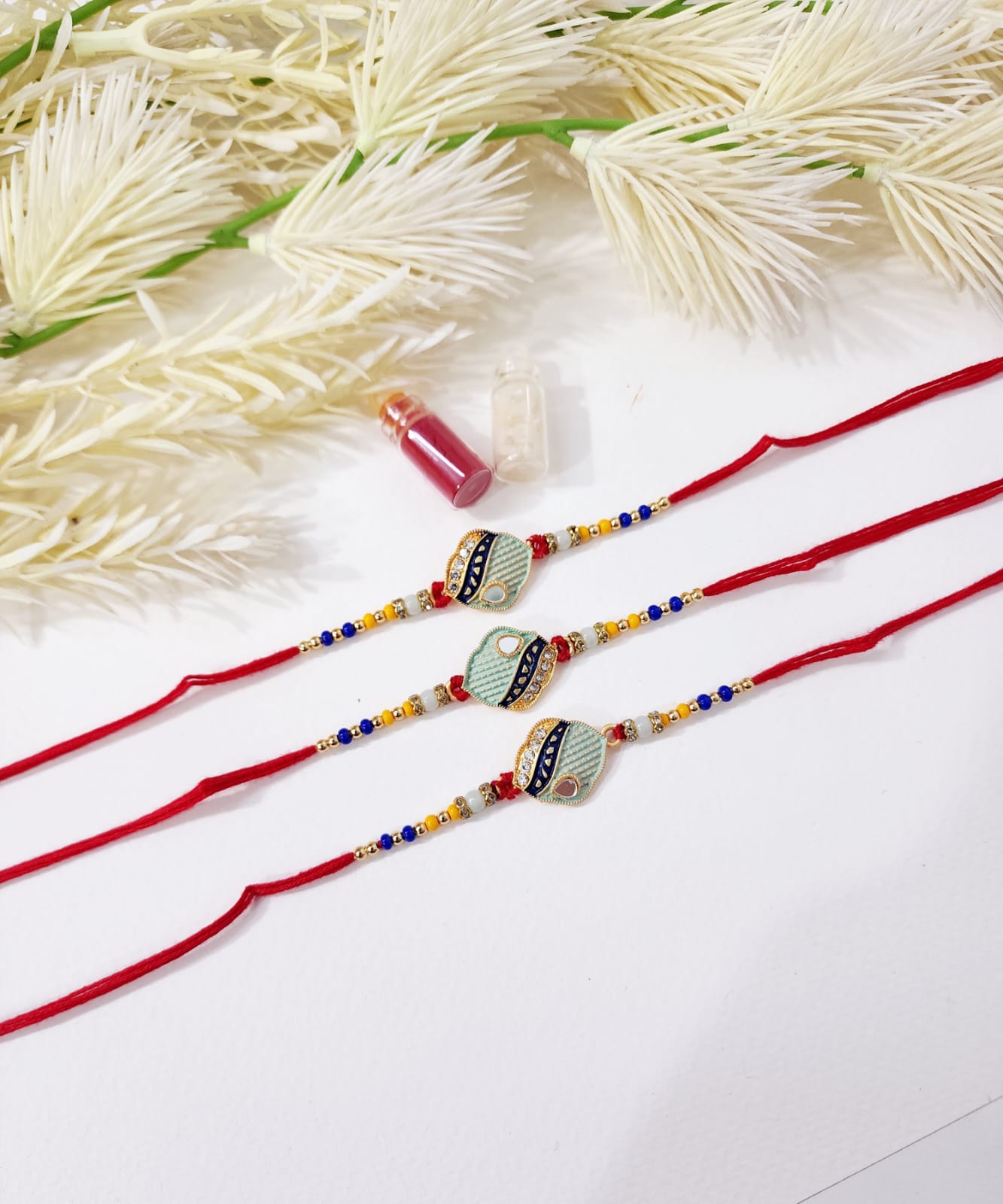 Two red strings with decorative elements on a white background