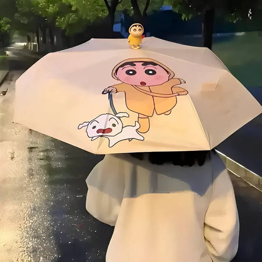 Person holding a cartoon-themed umbrella with a character and dog illustration on a rainy street.