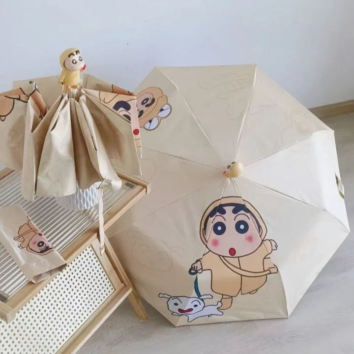 Beige umbrella with cartoon character design on a light surface