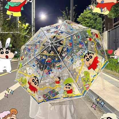 Transparent umbrella with cartoon character design on a street at night.