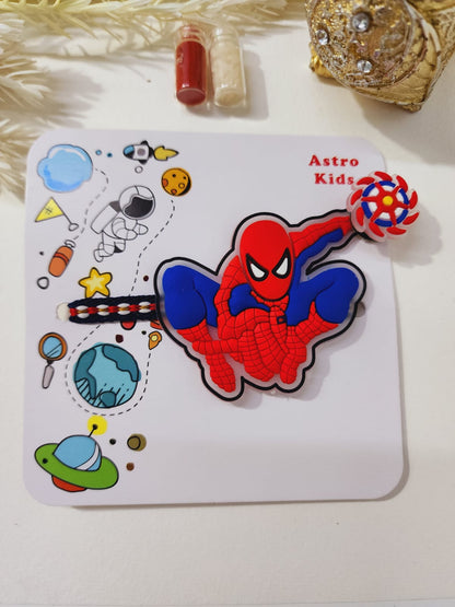 A colorful spinner rakhi featuring a cartoon character with a red and blue costume, surrounded by decorative elements like stars, planets, and a candy.