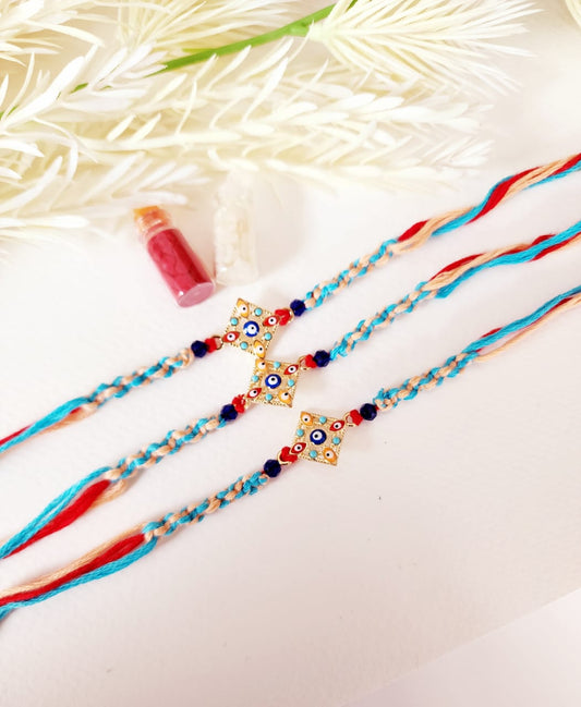 Two colorful rakhi necklaces with decorative beads on a light background