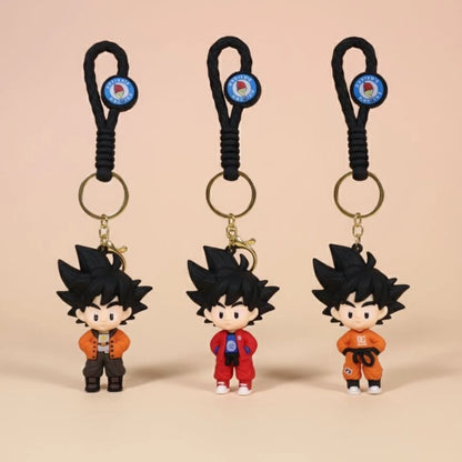 Three keychains with cartoon character figures on a beige background