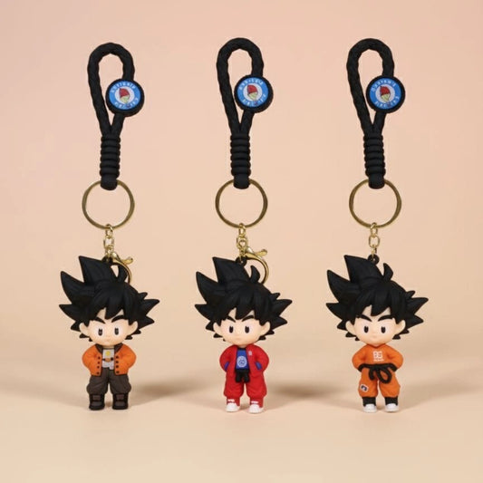 Three keychains with cartoon character figures on a beige background