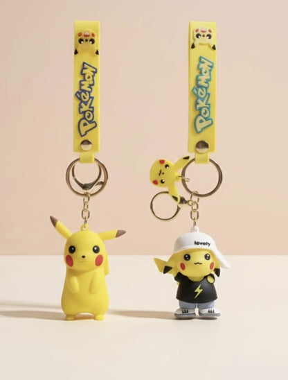 Two Pikachu keychains with different poses on a beige background