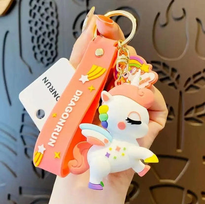 Unicorn keychain held by a hand with a decorative background