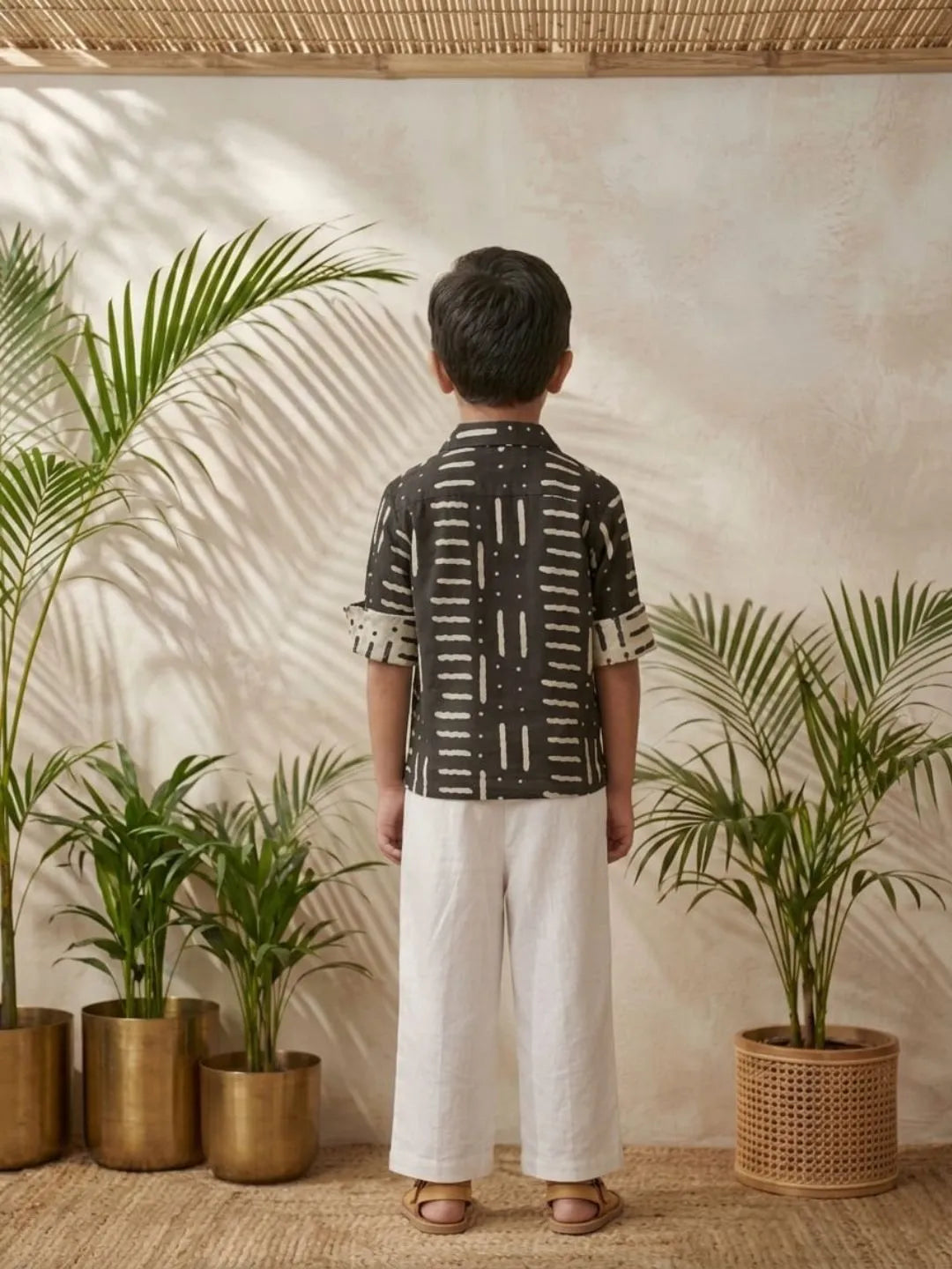 Boys black printed shirt and white trouser co-ord set back view