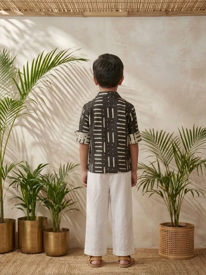 Boys black printed shirt and white trouser co-ord set back view