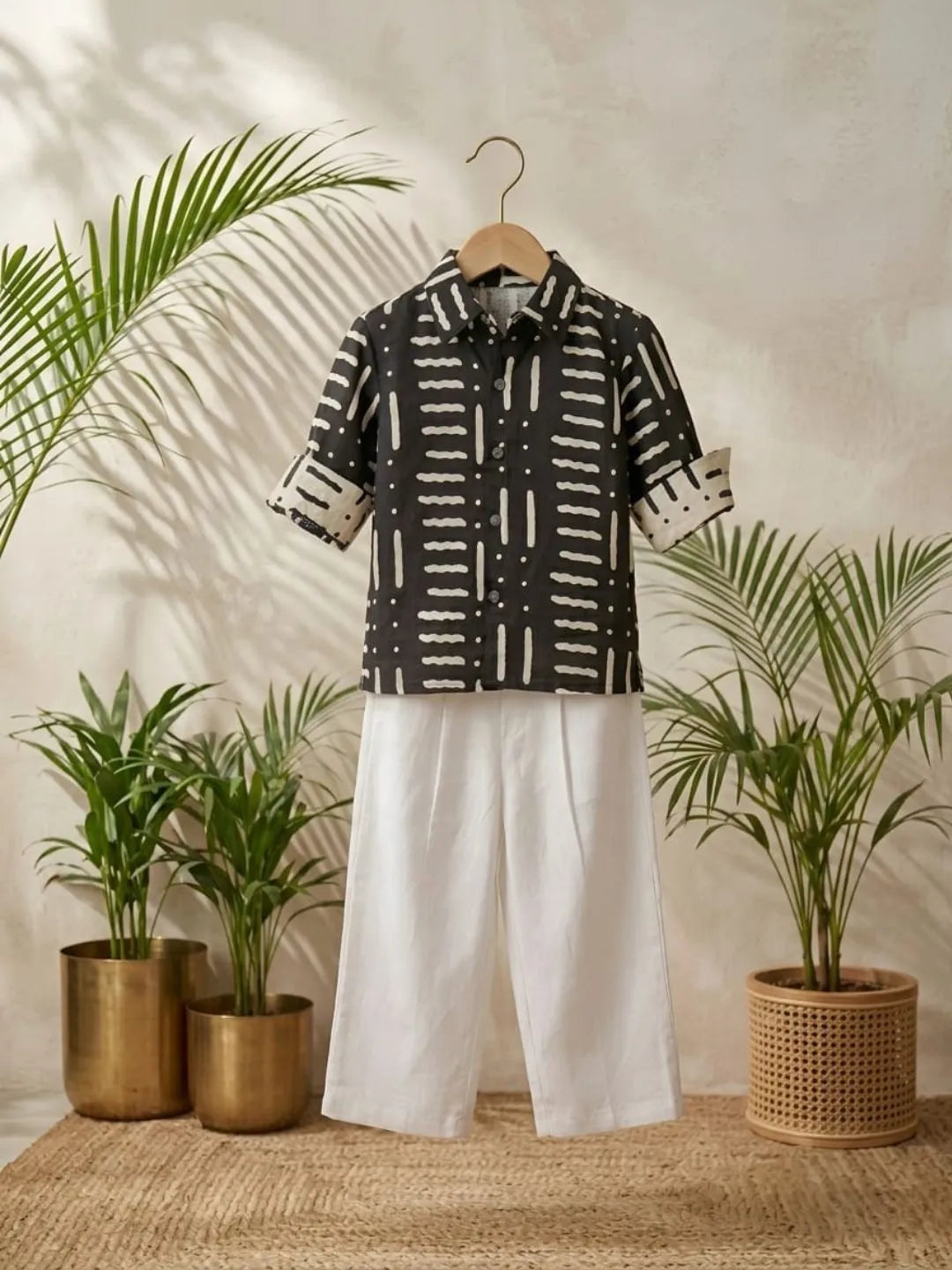 Boys black printed cotton shirt with white trouser co-ord set front view