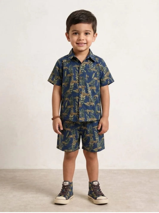 Child wearing a blue patterned shirt and shorts set on a white background