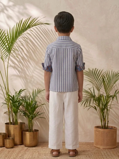 Boys blue striped shirt and white trouser outfit back view