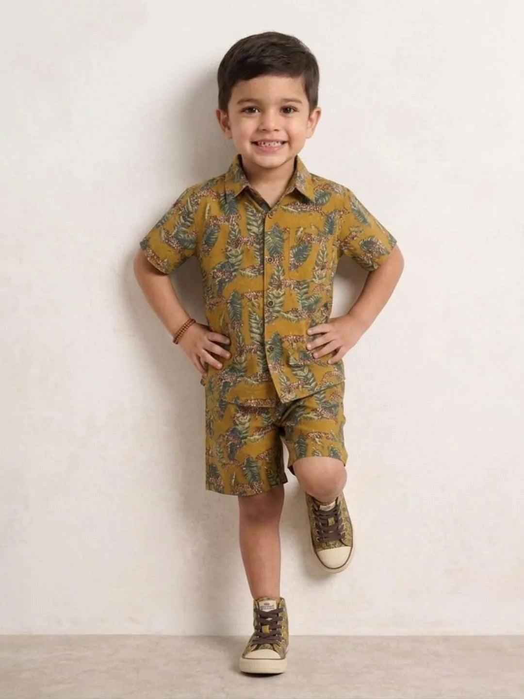 Child wearing a patterned outfit with a plain background